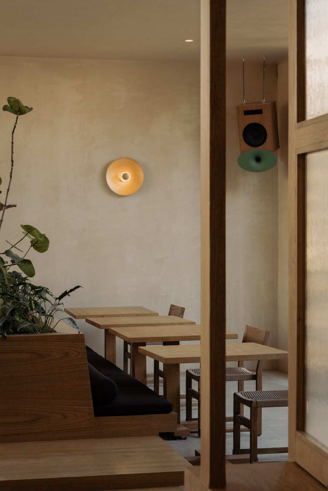 Wooden tables and warm lighting inside Gamba